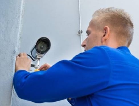 ADT home security technician installing camera