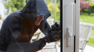 Image of burglar attempting to break into home