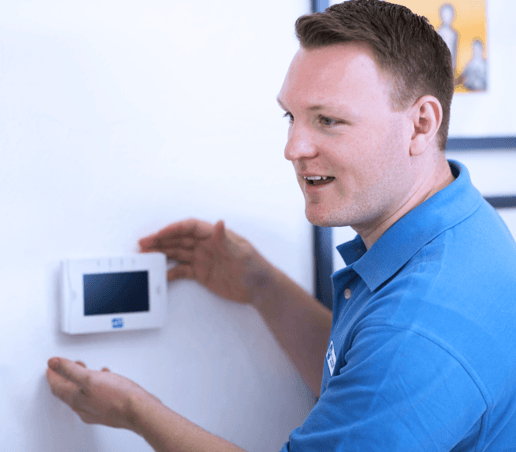 Technician installing home security keypad